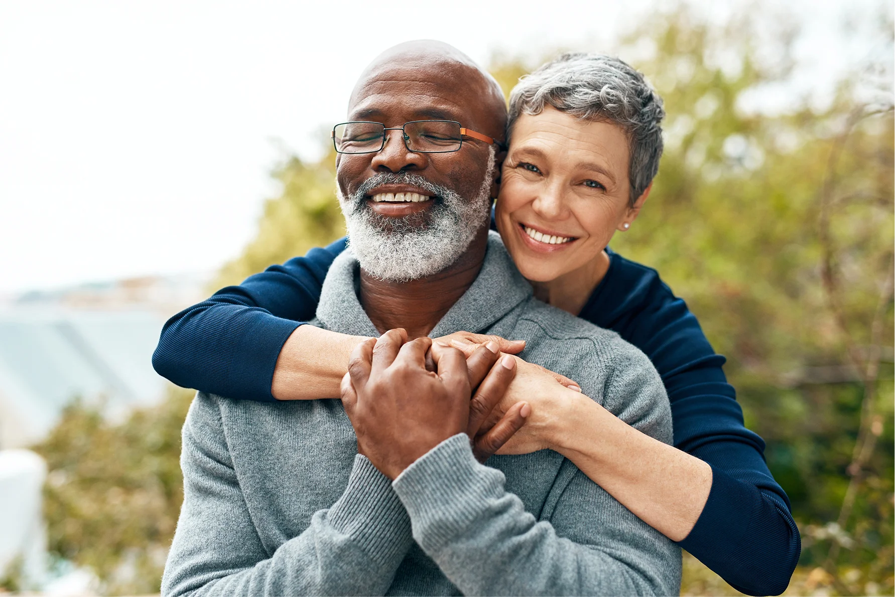 Happy senior couple embracing outdoors and enjoying time together